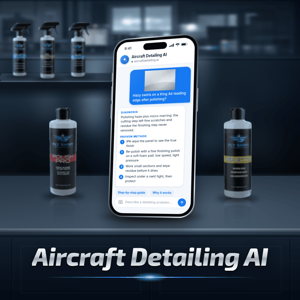 Aircraft Detailing AI on a phone between Fly Shiny Polish Pro and Reflection bottles. A detailer sends a photo of hazy swirls on a King Air leading edge, and the AI answers with a diagnosis (polishing haze plus micro-marring) and a step-by-step method.